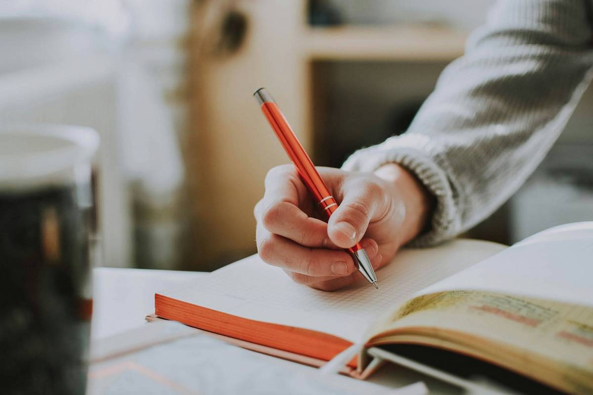 An individual reflecting by journaling