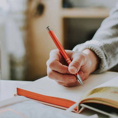 An individual reflecting by journaling