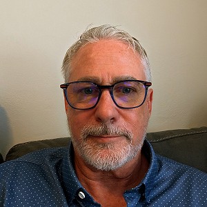 Compassionate and experienced recovery specialist, Mike Shea, standing confidently in a serene natural setting that reflects his love for nature and personal journey of transformation and healing