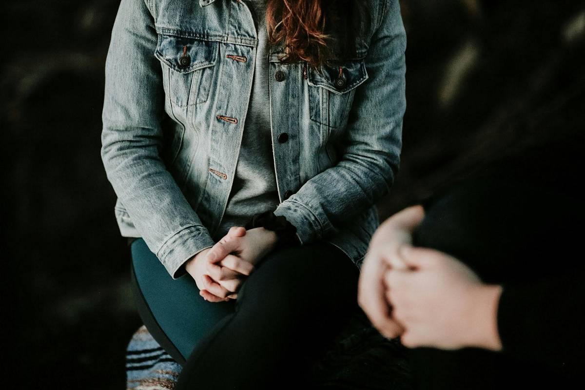 A woman undergoing a therapy session for addiction recovery