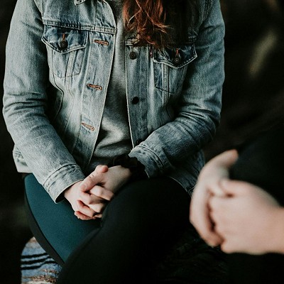 A woman undergoing a therapy session for addiction recovery