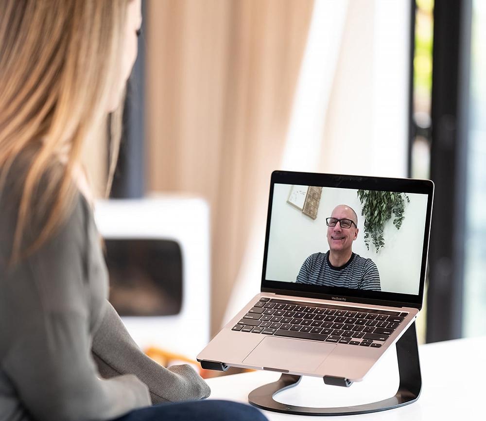 In Nanaimo, BC, Michael Walsh, a certified recovery coach, conducts a personalized one-on-one coaching session with a client via his laptop.